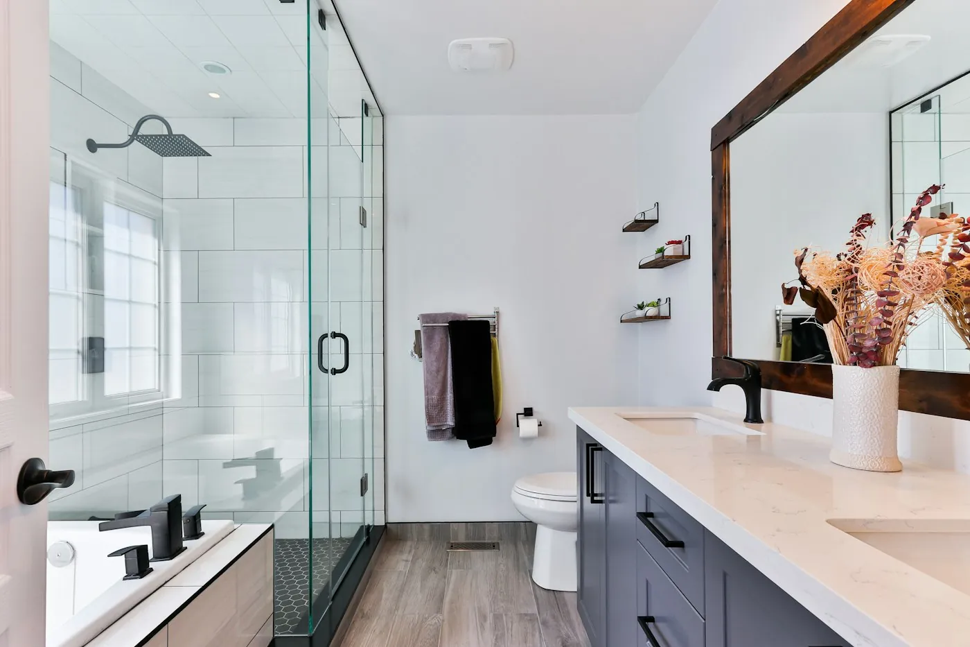 Remodeled bathroom with a glass shower and a long vanity