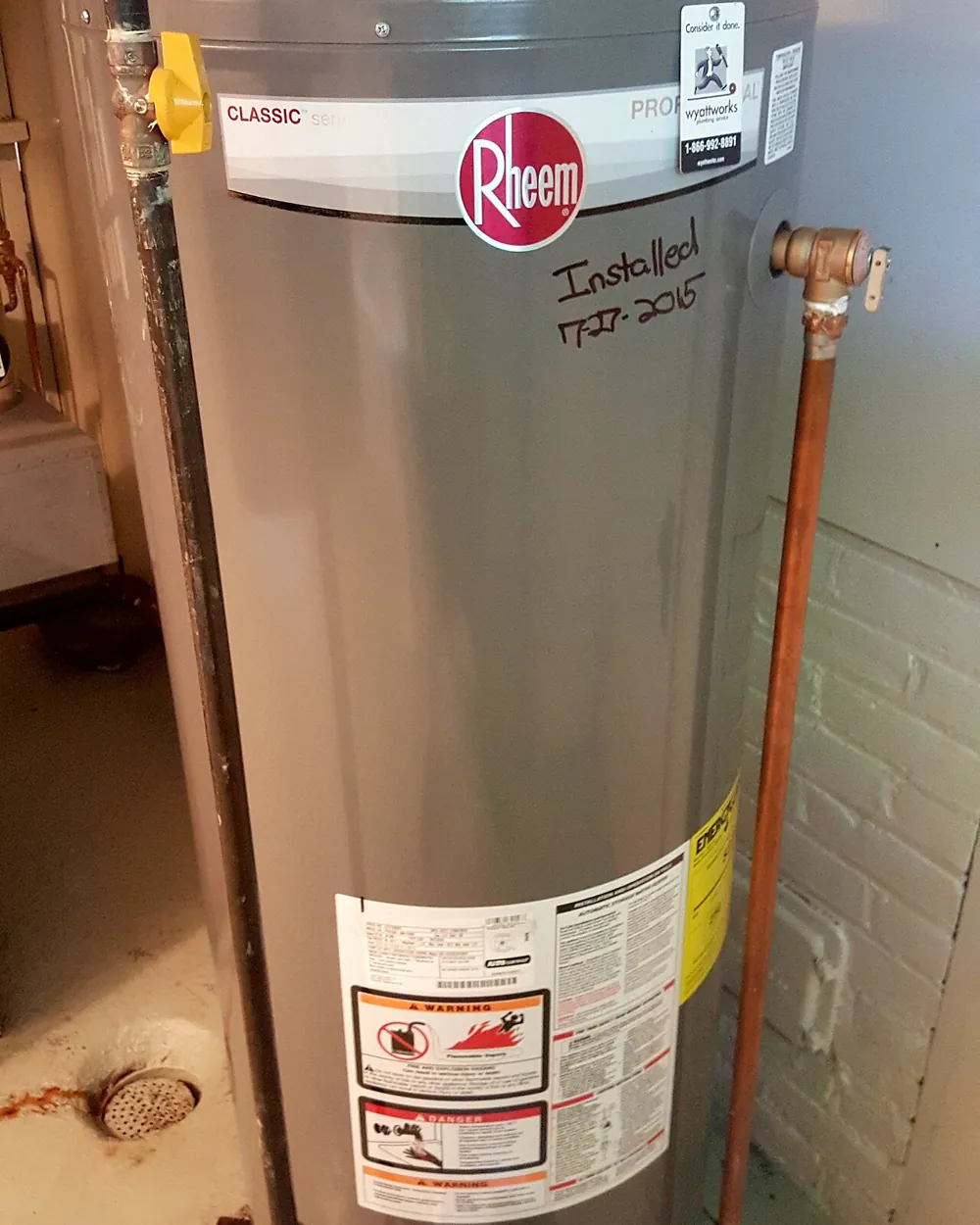 New gas water heater tank installed with copper lines